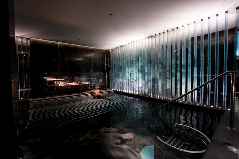 A black pool with a single guy in it