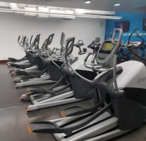 Spinning class with spotlights on the coach