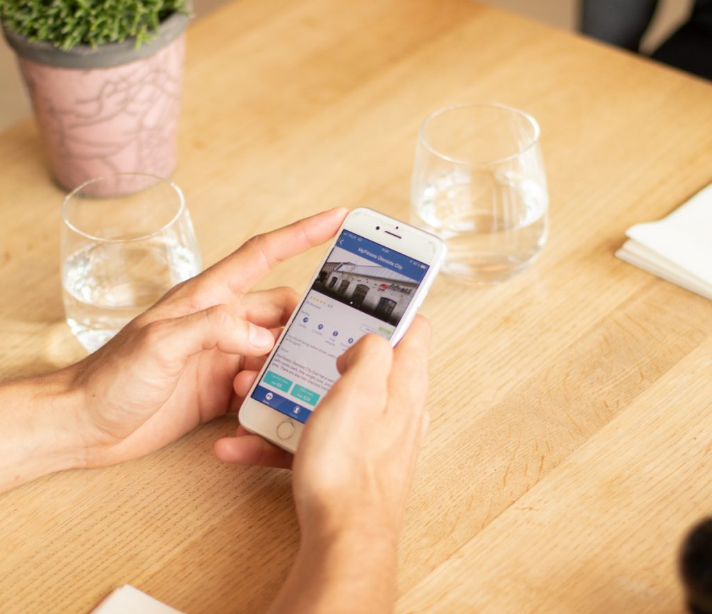 hands holding iphone looking at gym in TrainAway App